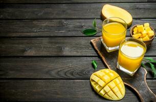 Mango juice in a glass on a cutting Board. photo