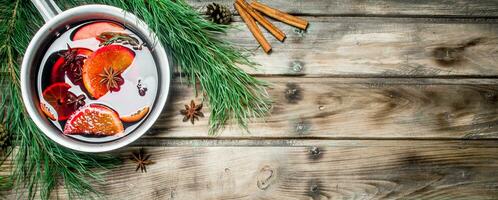 Mulled wine in a pot of spices. photo