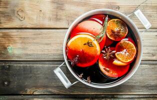 Mulled wine in a pot of spices. photo