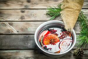 Mulled wine in a pot of spices. photo