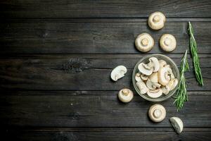 Pieces of fresh mushrooms in a bowl with greens. photo