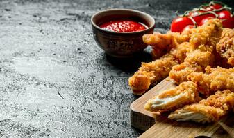 Chicken strips with cherry and tomato sauce. photo
