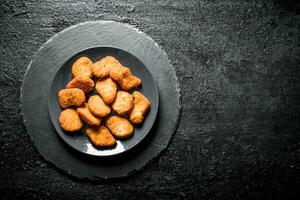 Chicken nuggets on the plate. photo