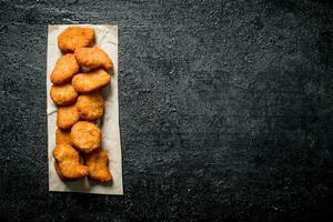 Chicken nuggets on paper. photo