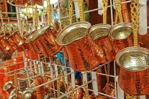 small elegant copper turkish coffee pots in the shop on display photo