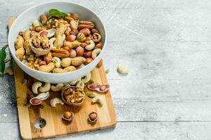 Different kinds of nuts in bowl . photo