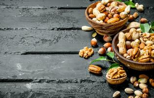 Assortment of different types of nuts in bowls. photo