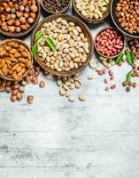 Assortment of different nuts in bowls. photo