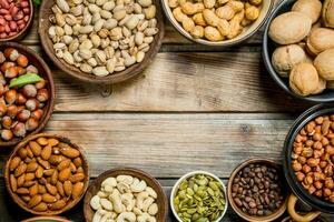 Assortment of different nuts in bowls. photo