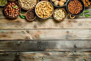 Assortment of different nuts in bowls. photo