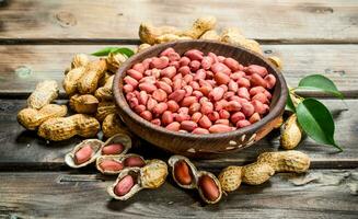 The shelled peanuts in a bowl . photo