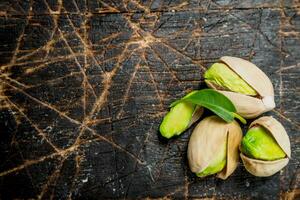 Pistachios with green leaves . photo