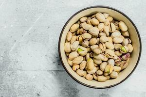 Pistachios in the bowl . photo