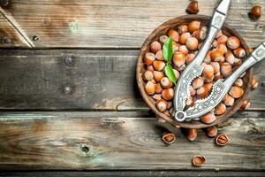 Hazelnuts in a bowl with a Nutcracker. photo