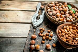 Hazelnuts with Nutcracker on the old Board . photo