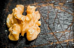 Peeled walnut . On a wooden background. photo