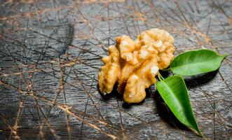 Shelled walnut with green leaves. photo