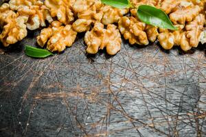 Shelled walnut with green leaves. photo