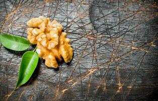 Shelled walnut with green leaves. photo