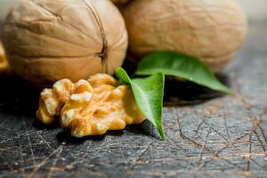 Shelled walnut with green leaves. photo