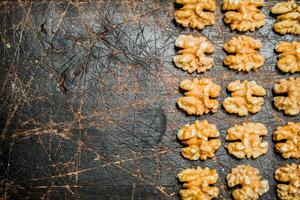 Peeled walnut on wooden background. photo