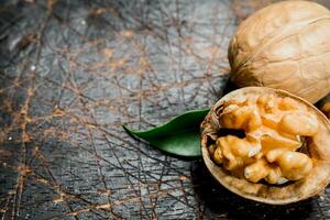 Shelled walnut with green leaves. photo