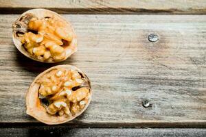 Peeled walnut on wooden board . photo