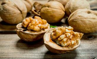 Peeled walnut on wooden board . photo