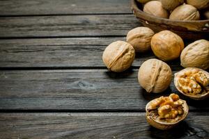 Peeled walnut on wooden background. photo