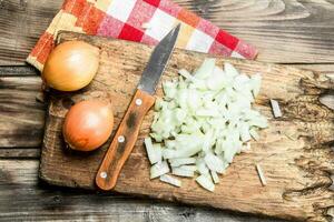 Sliced onions on a cutting Board with a knife on a napkin. photo