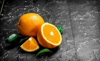 Fresh ripe oranges with leaves. photo