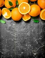 Fresh ripe oranges with leaves. photo