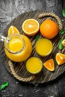 The juice from the oranges in the pitcher on the tray. photo