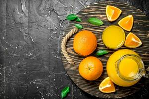 The juice from the oranges in the pitcher on the tray. photo