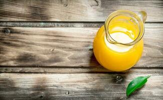 Orange juice in the pitcher. photo