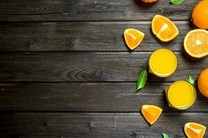 Orange juice in a glass of fresh oranges. photo