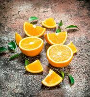 Pieces of fresh oranges with leaves. photo