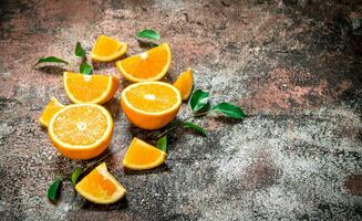 Pieces of fresh oranges with leaves. photo