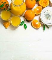 Orange juice in pitcher and juicer. photo