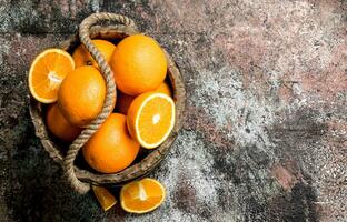 Fresh oranges in an old bucket. photo