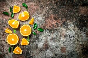 Pieces of fresh oranges with leaves. photo