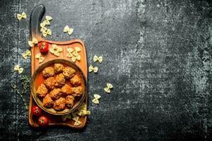 Meat balls in pan and pasta. photo