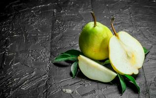 Pieces of ripe pear with leaves. photo