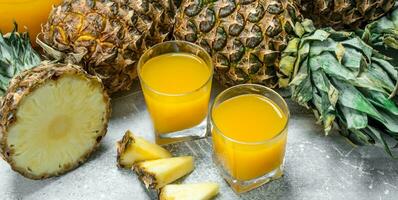 Fresh pineapple juice and ripe pineapples. photo