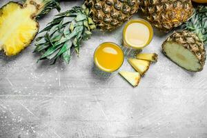Fresh pineapple juice and ripe pineapples. photo