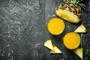 The juice of ripe pineapples in the glass. photo