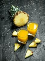 The juice of ripe pineapples in the glass. photo