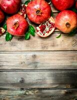 Fresh fragrant pomegranates with leaves. photo