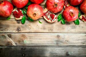 Fresh fragrant pomegranates with leaves. photo