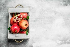 Fresh pomegranate in the box. photo